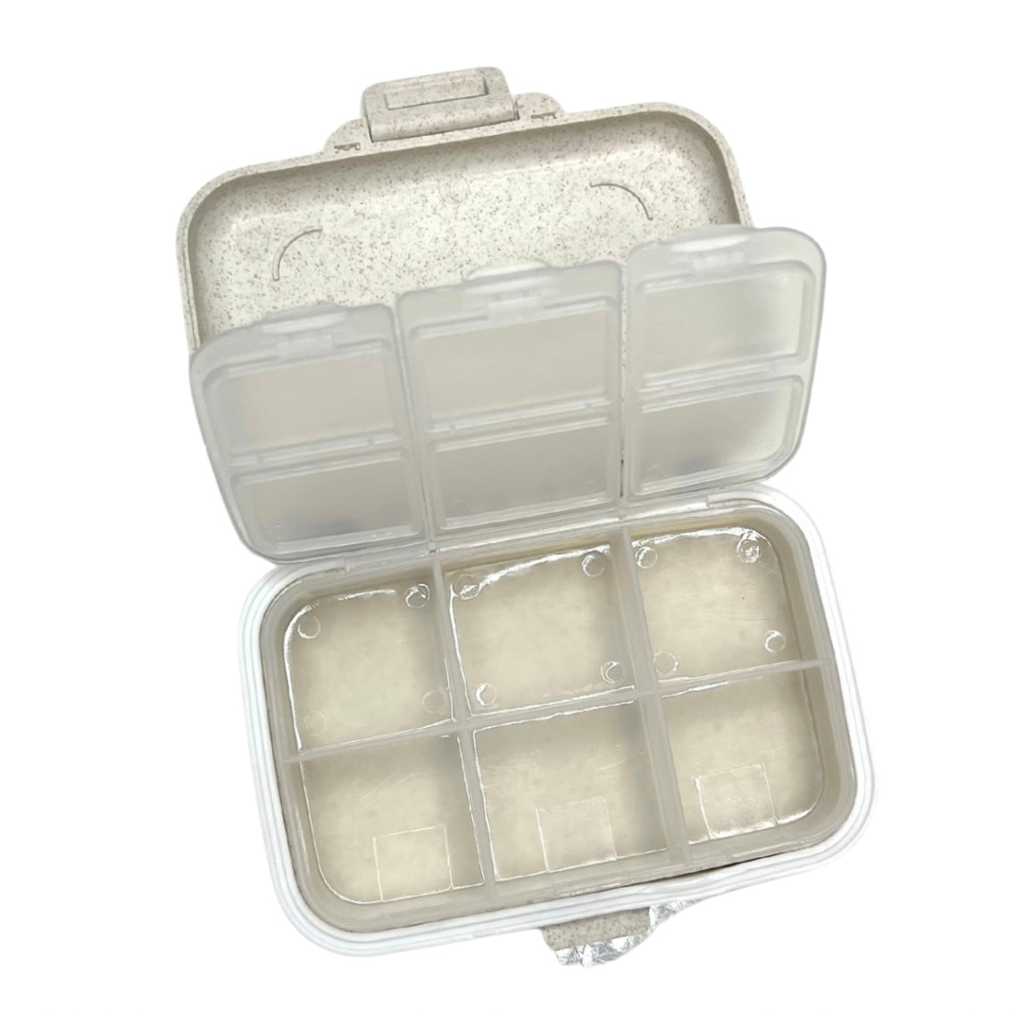 Clear plastic compartmentalized container with a lid on a white background