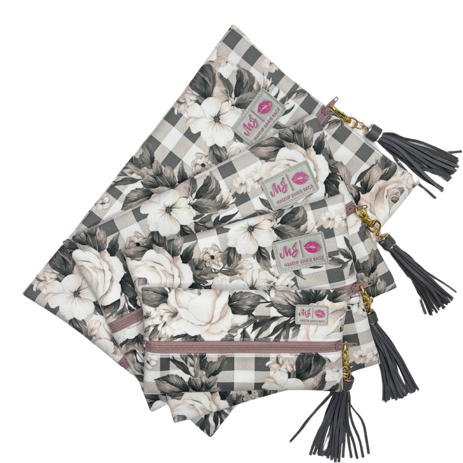 Set of floral and checkered pouches with tassels on a white background