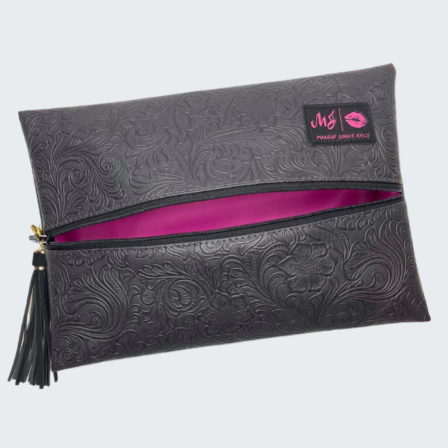 Black embossed clutch bag with a pink interior and visible brand logo on a white background