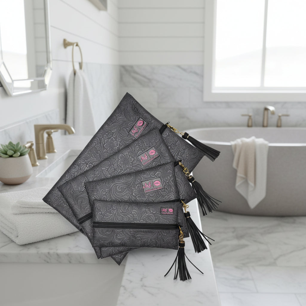 Set of black patterned pouches with tassels on a white background