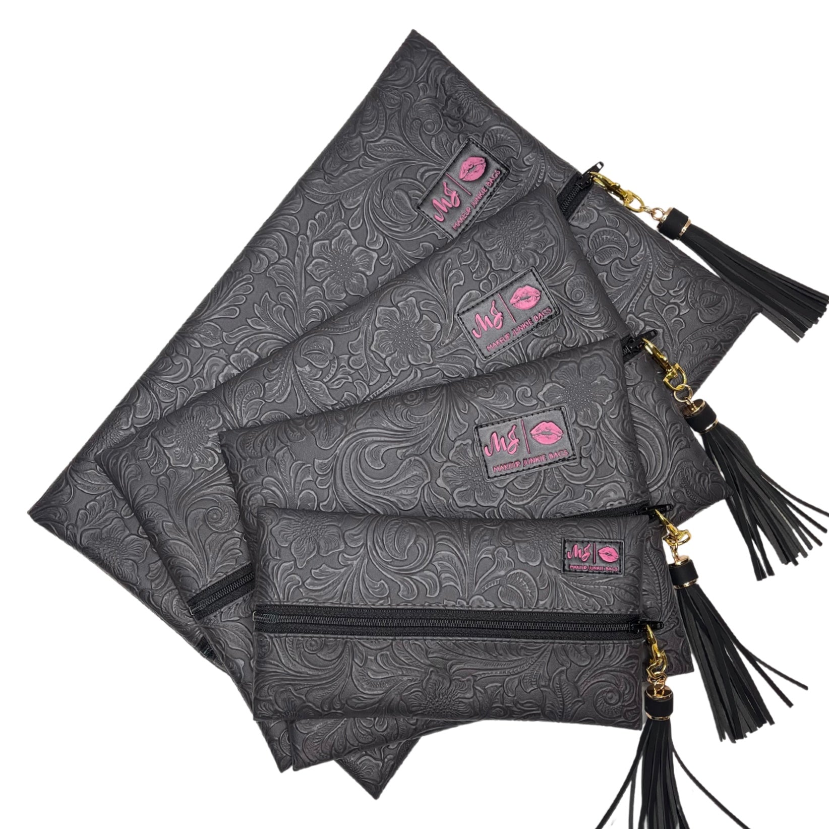 Set of black patterned pouches with tassels on a white background