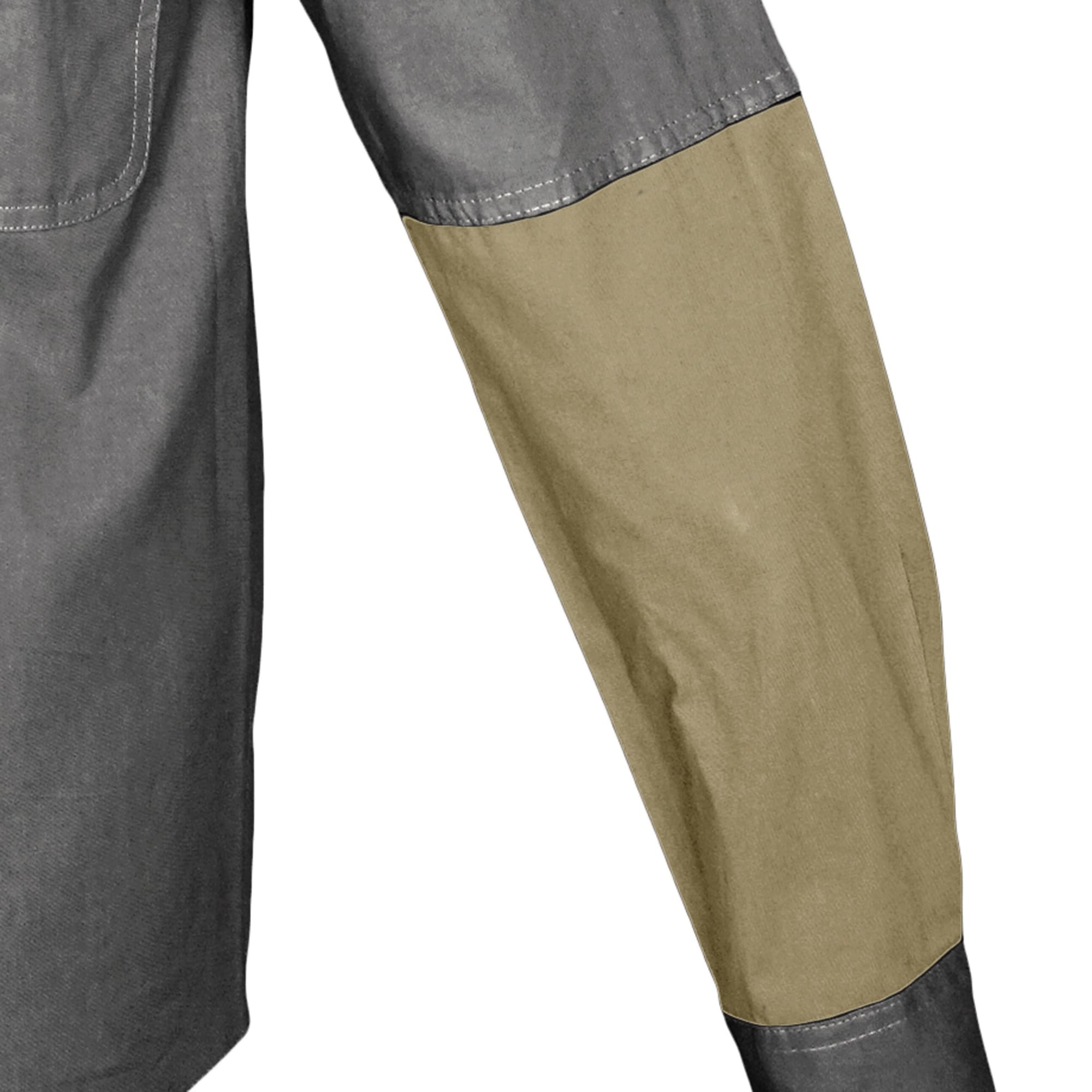 Close-up of a pair of pants with gray and beige sections on a white background