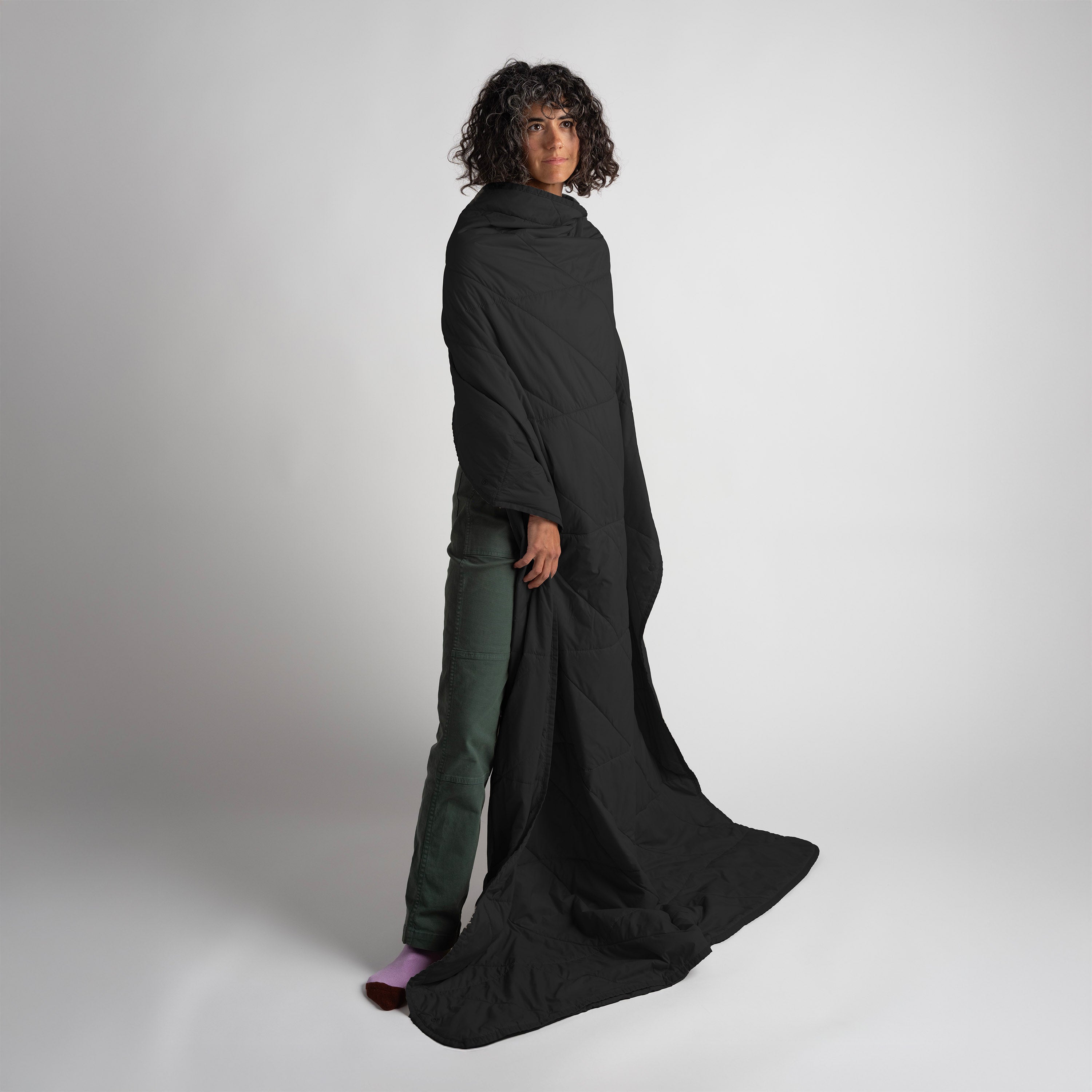 Person wearing a long black garment against a white background