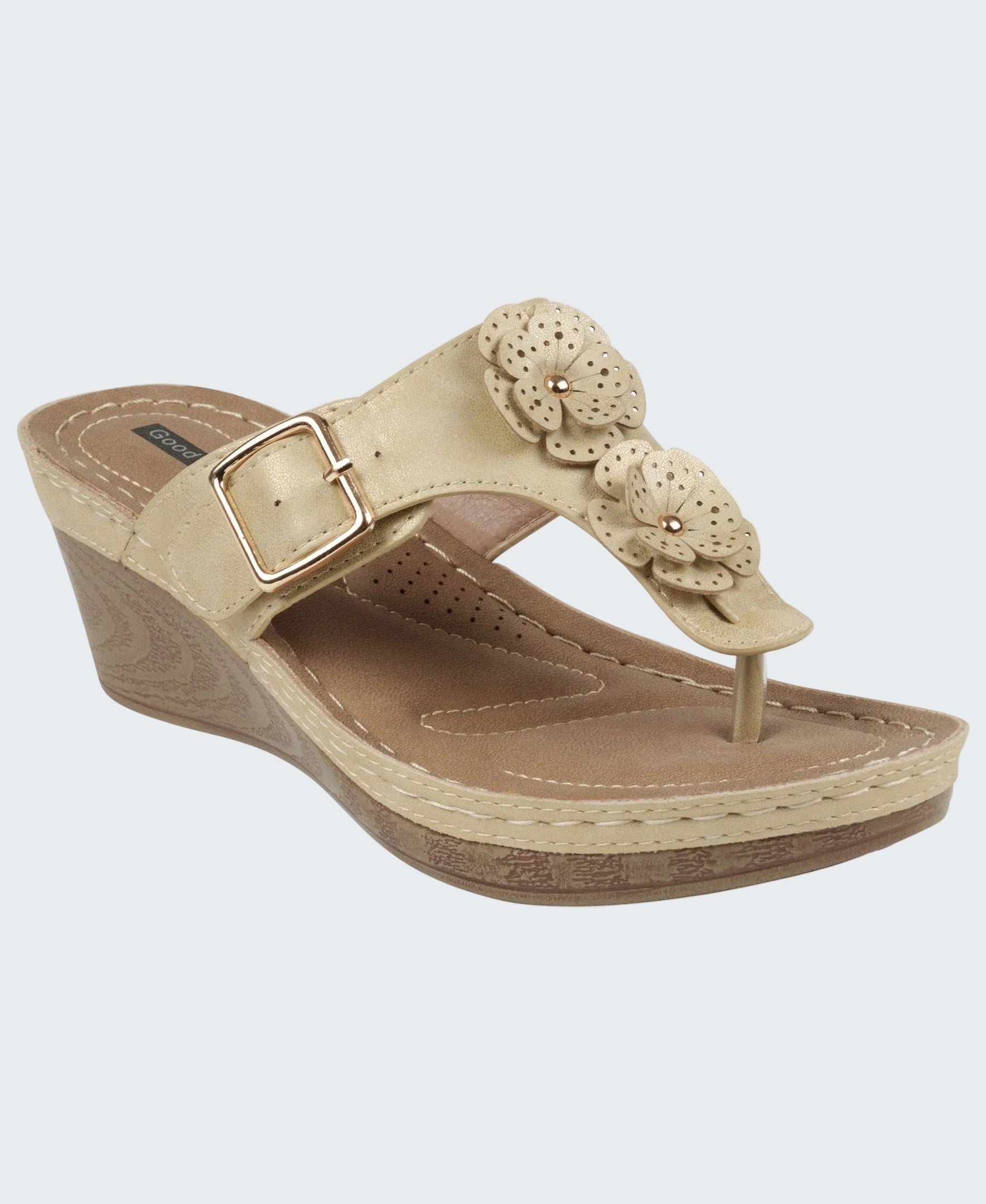 Beige wedge sandal with floral design on a white background
