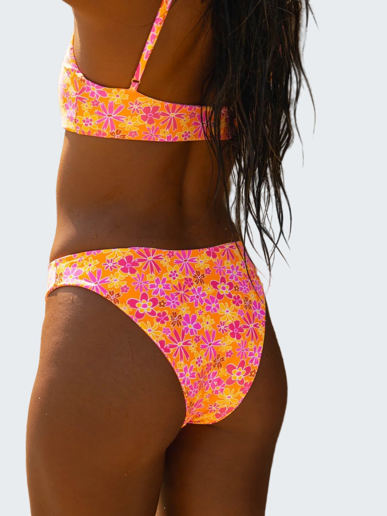 Person wearing a colorful floral bikini against a natural background