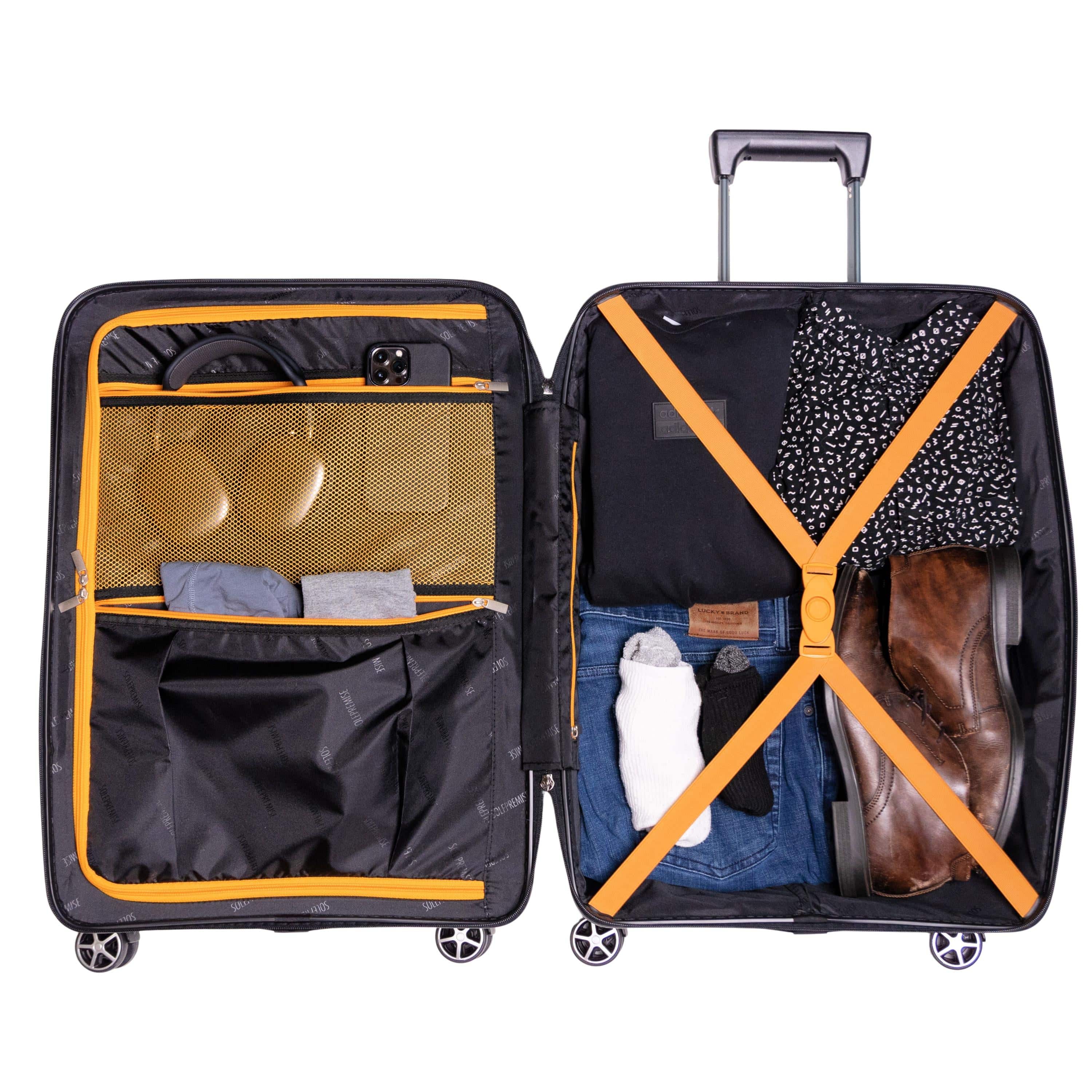Open suitcase with organized clothing items on a white background