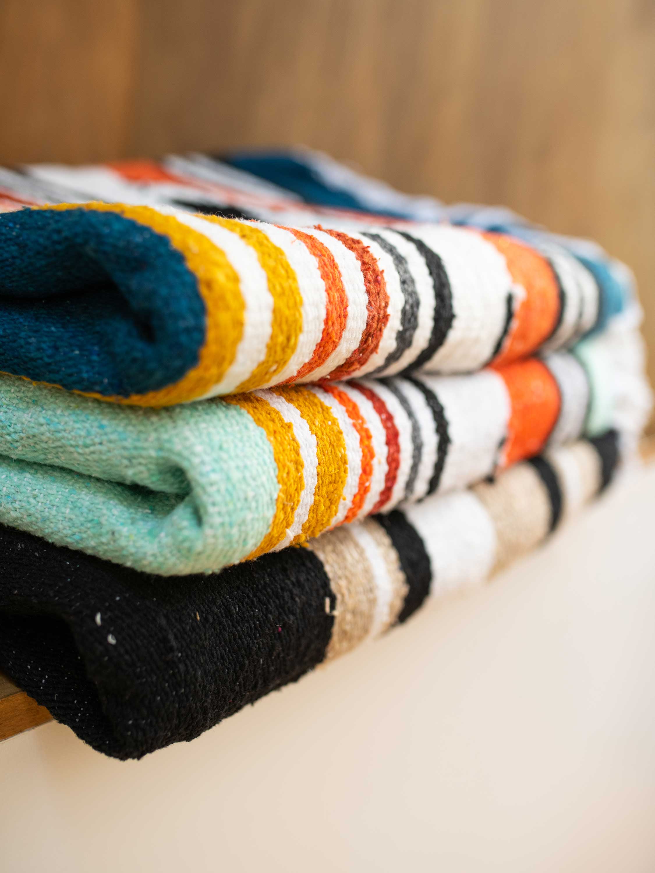 Stack of colorful striped socks on a wooden surface