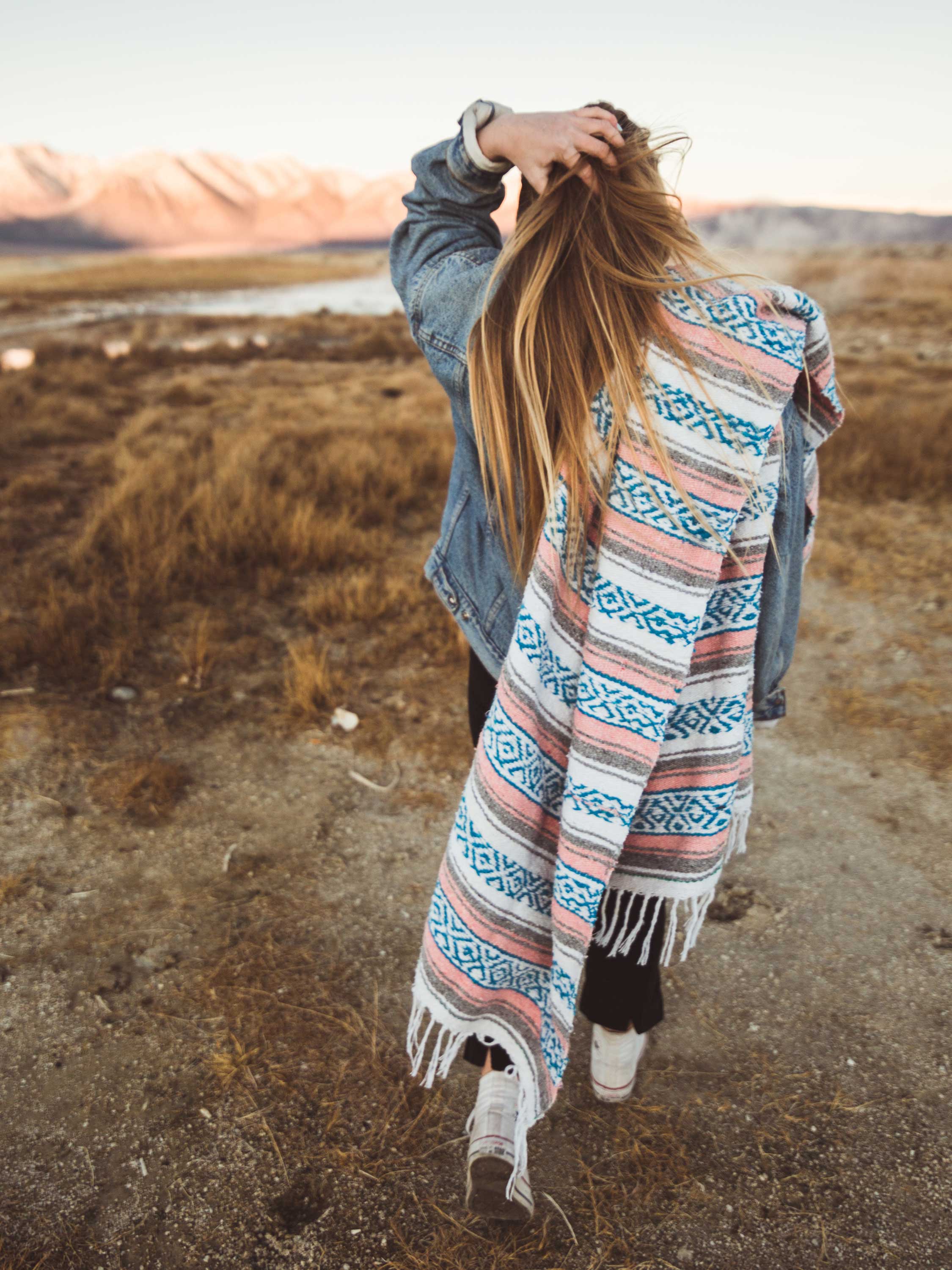 Person wearing a patterned scarf in a natural setting