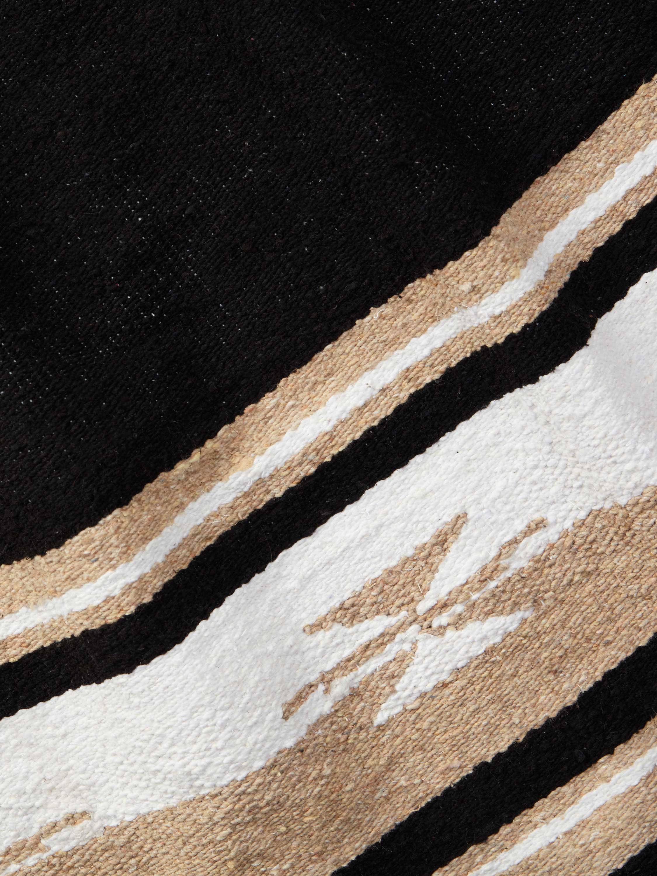 Close-up of a rug with geometric pattern on a black background