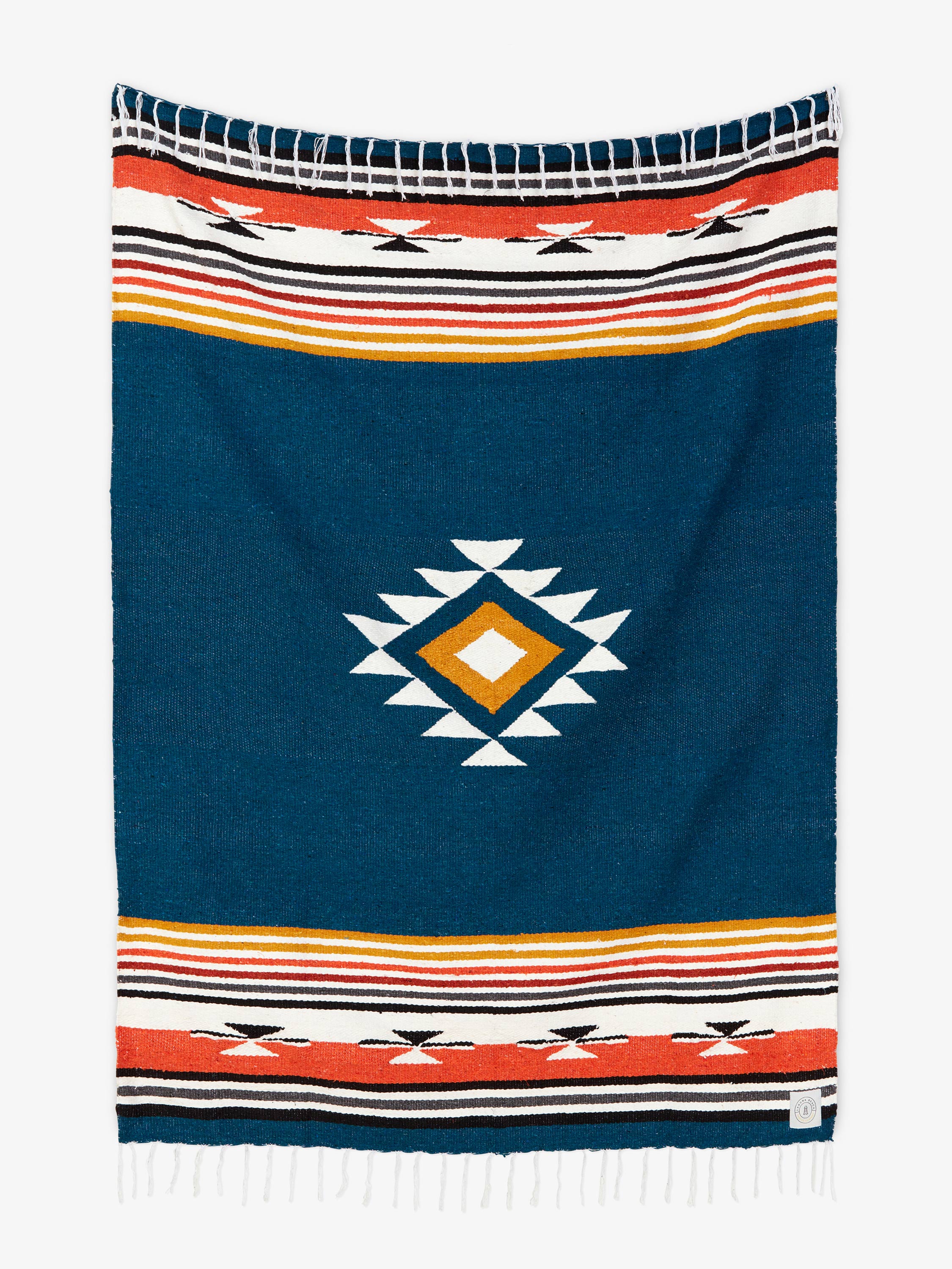 Navy blue blanket with geometric pattern and colorful stripes on a white background