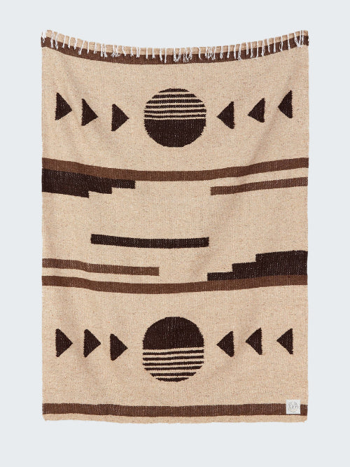 Beige blanket with black geometric patterns on a white background