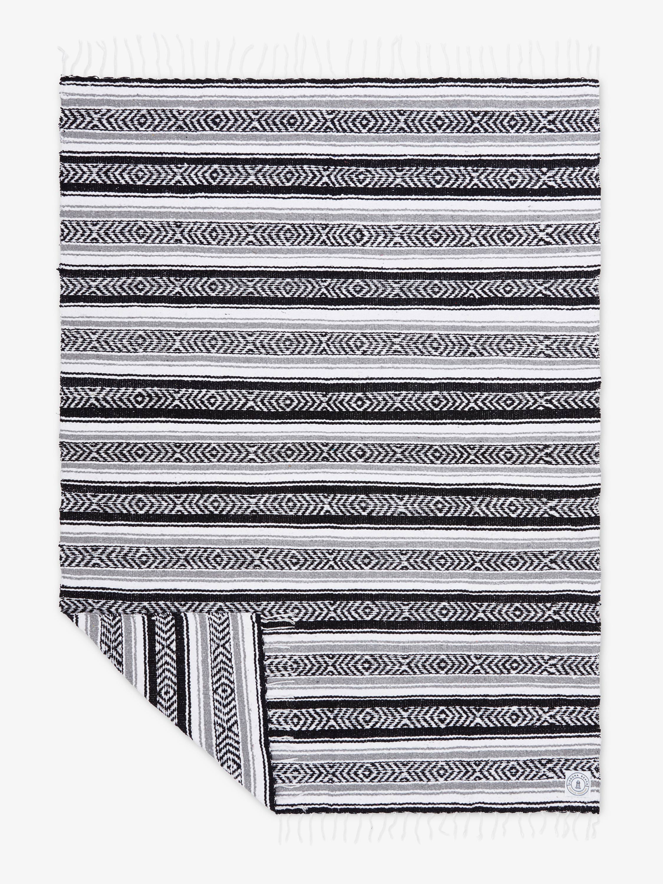 Black and white striped fabric with geometric patterns on a white background