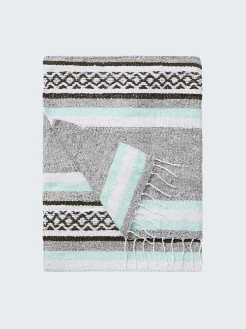 Gray blanket with black and white pattern and light blue accents on a white background