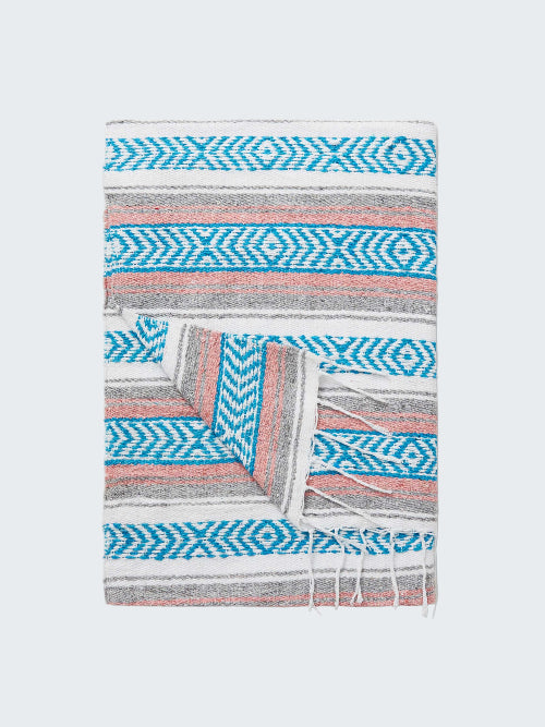 Patterned blanket with blue and pink design on a white background