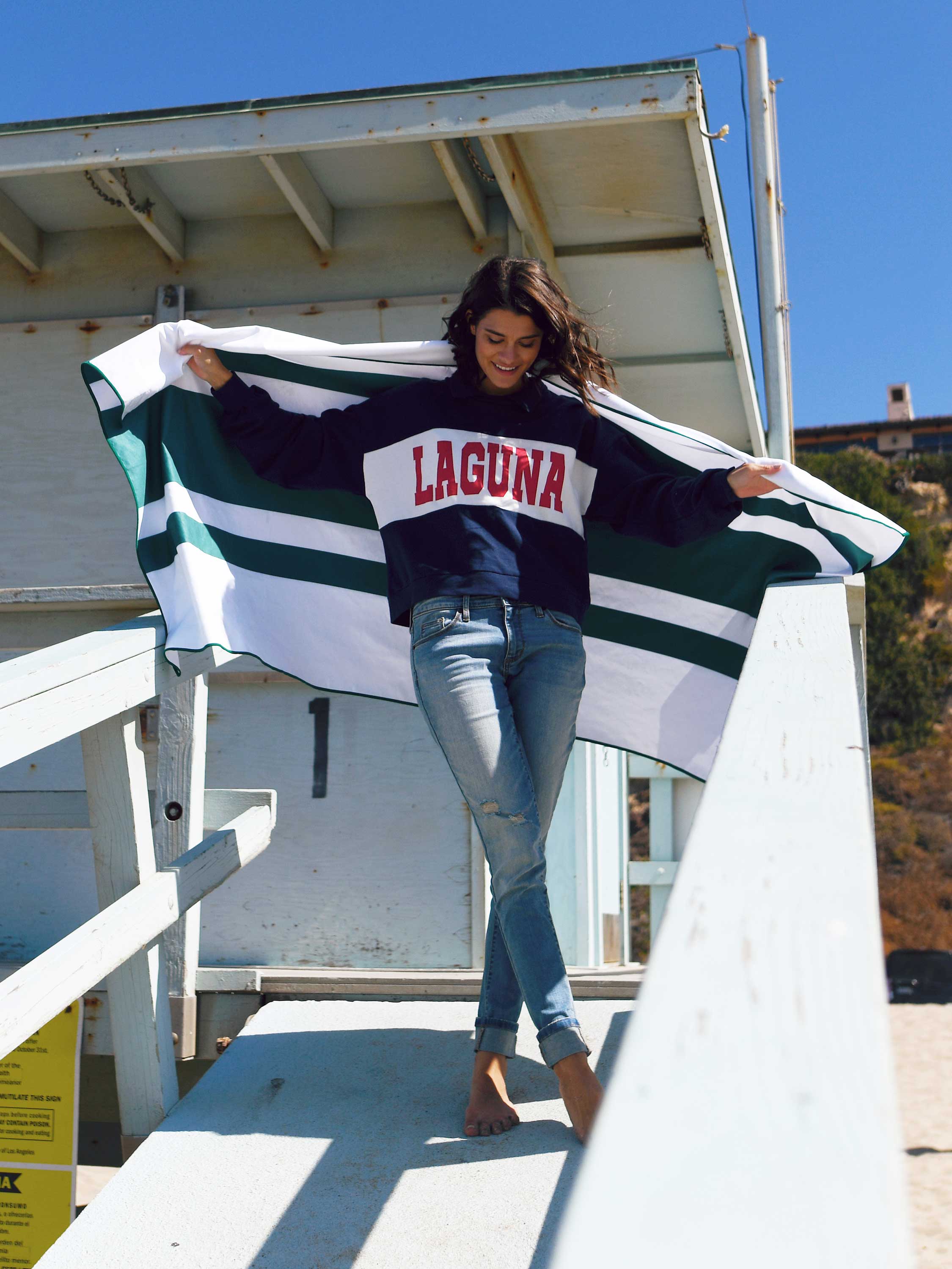 Person holding a flag with 'Laguna' text in an outdoor setting