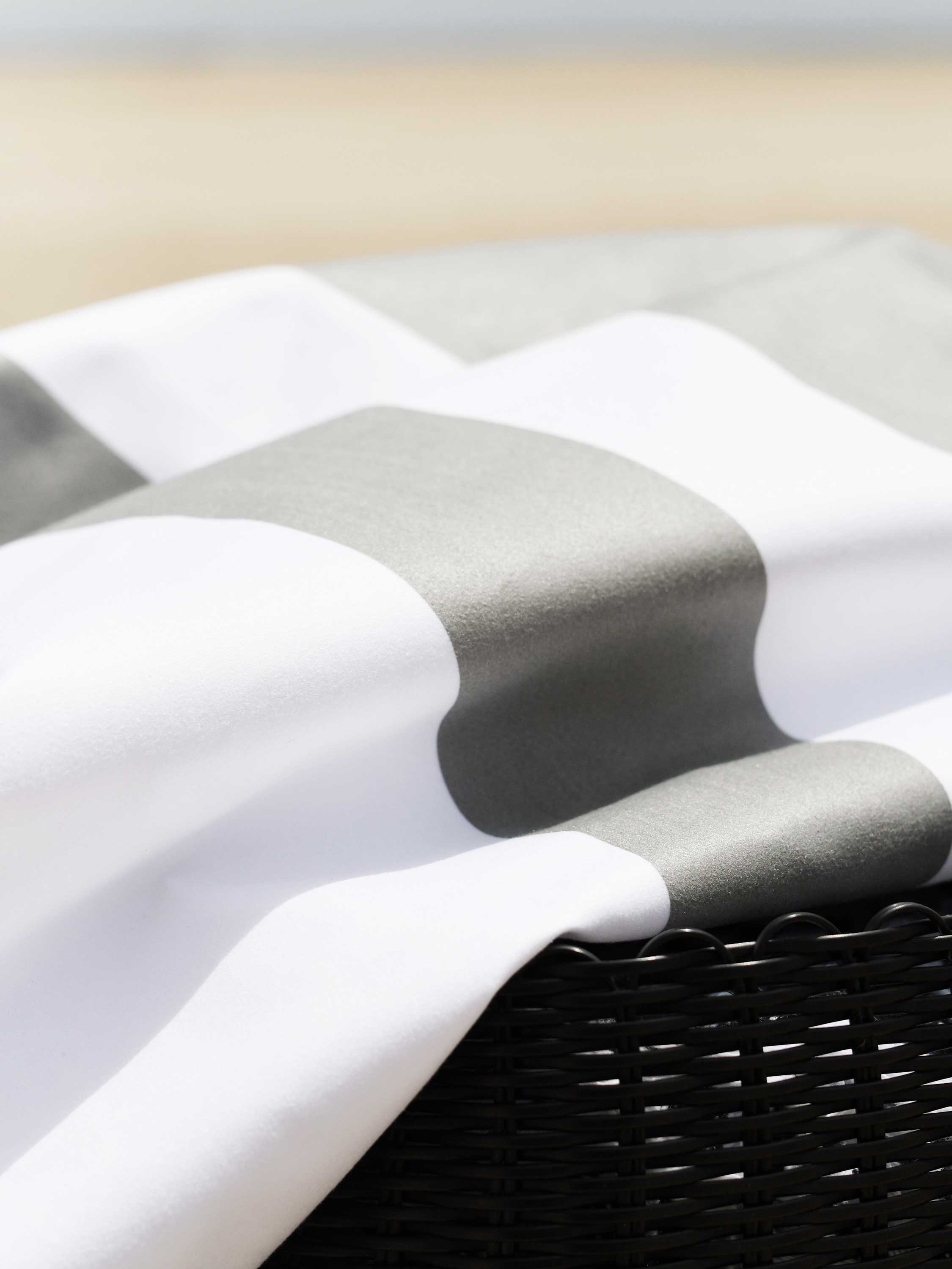 Close-up of a gray and white checkered fabric on a woven basket.