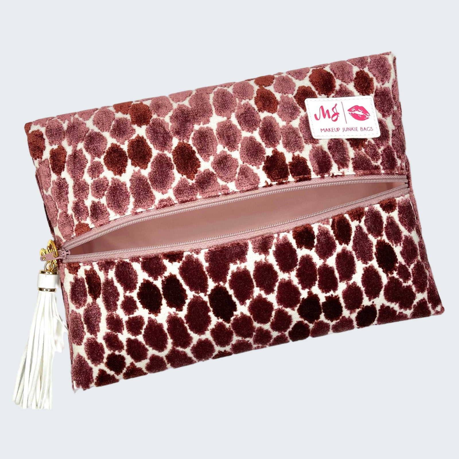 Makeup bag with a patterned design and visible brand logo on a white background