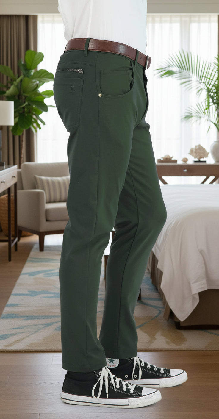 Green pants worn by a person on a white background