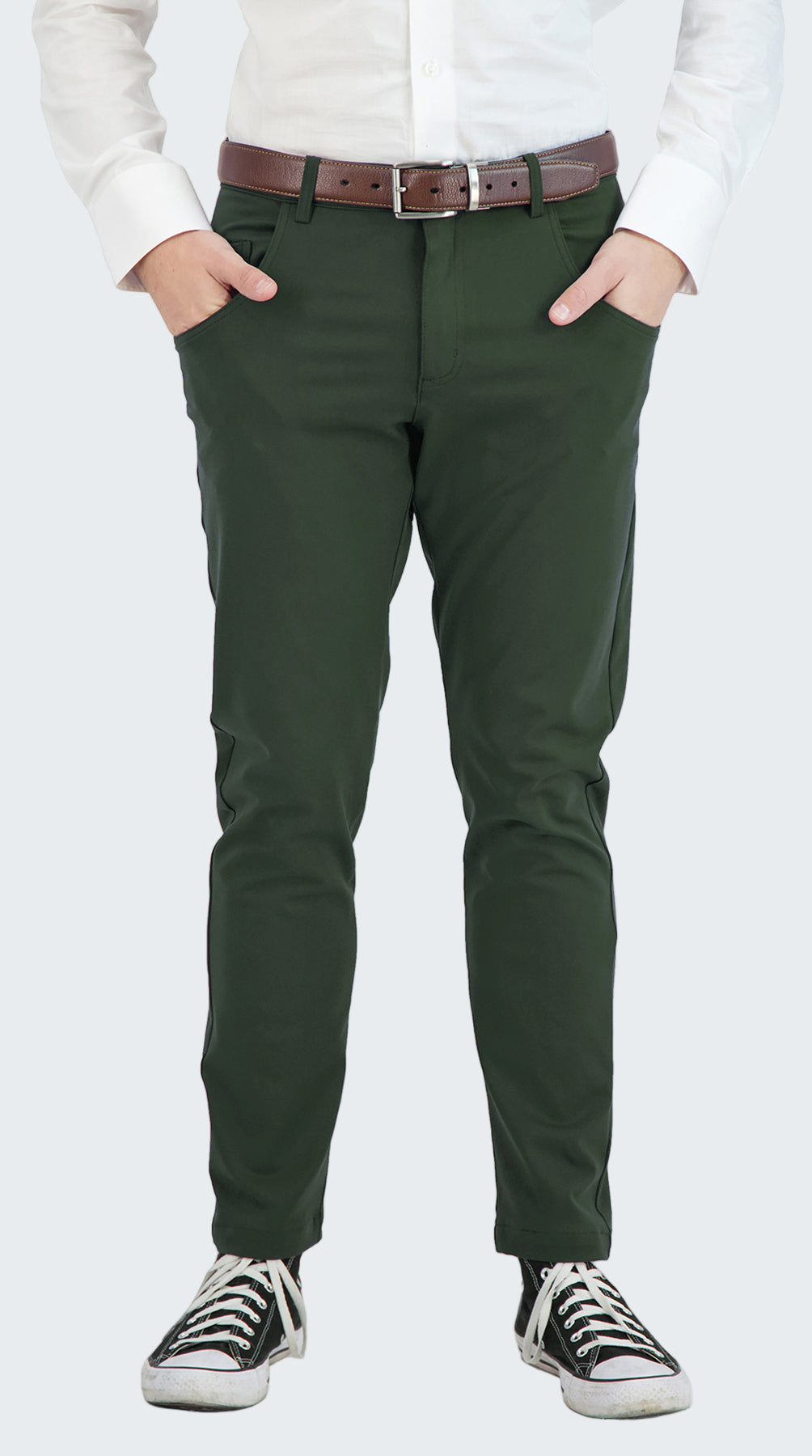 Person wearing green pants with a white shirt and black sneakers on a white background