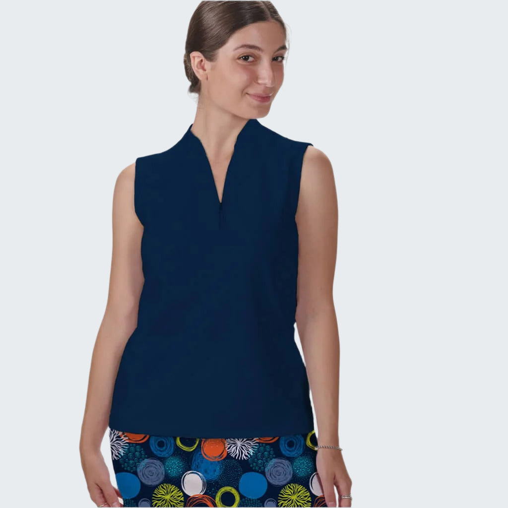 Woman wearing a navy sleeveless top with a colorful skirt on a white background