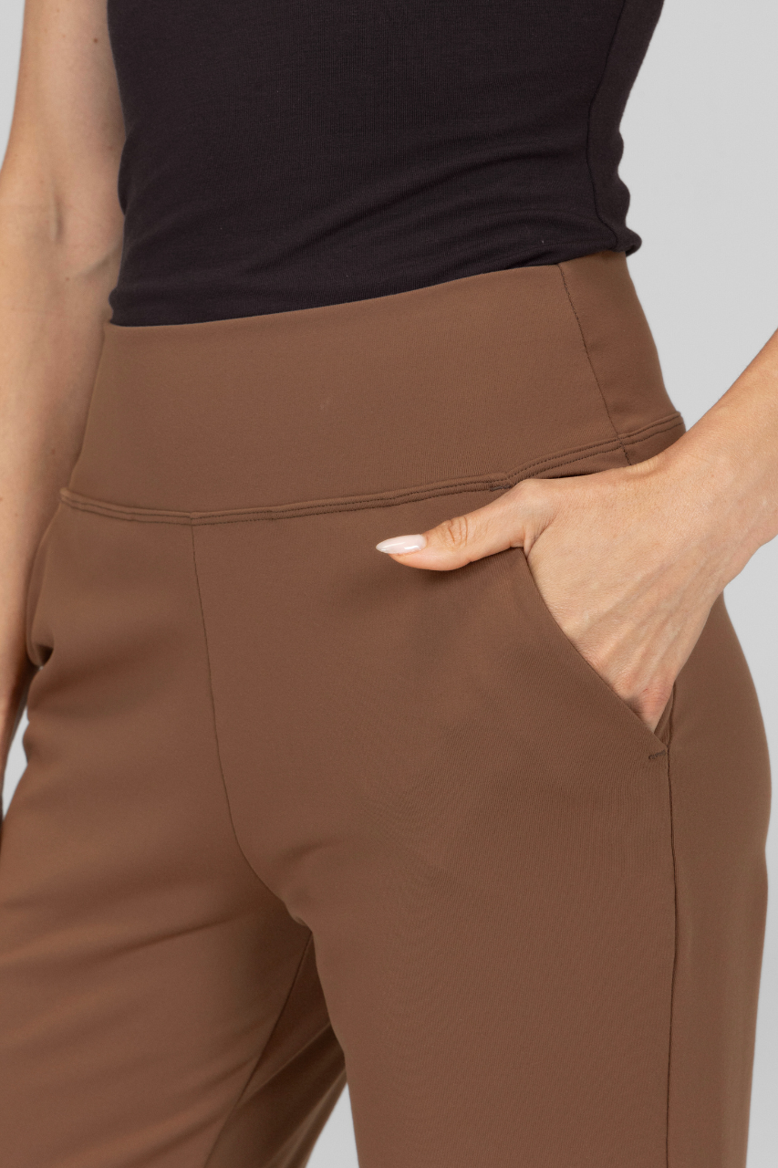 Brown pants worn by a person with a neutral background