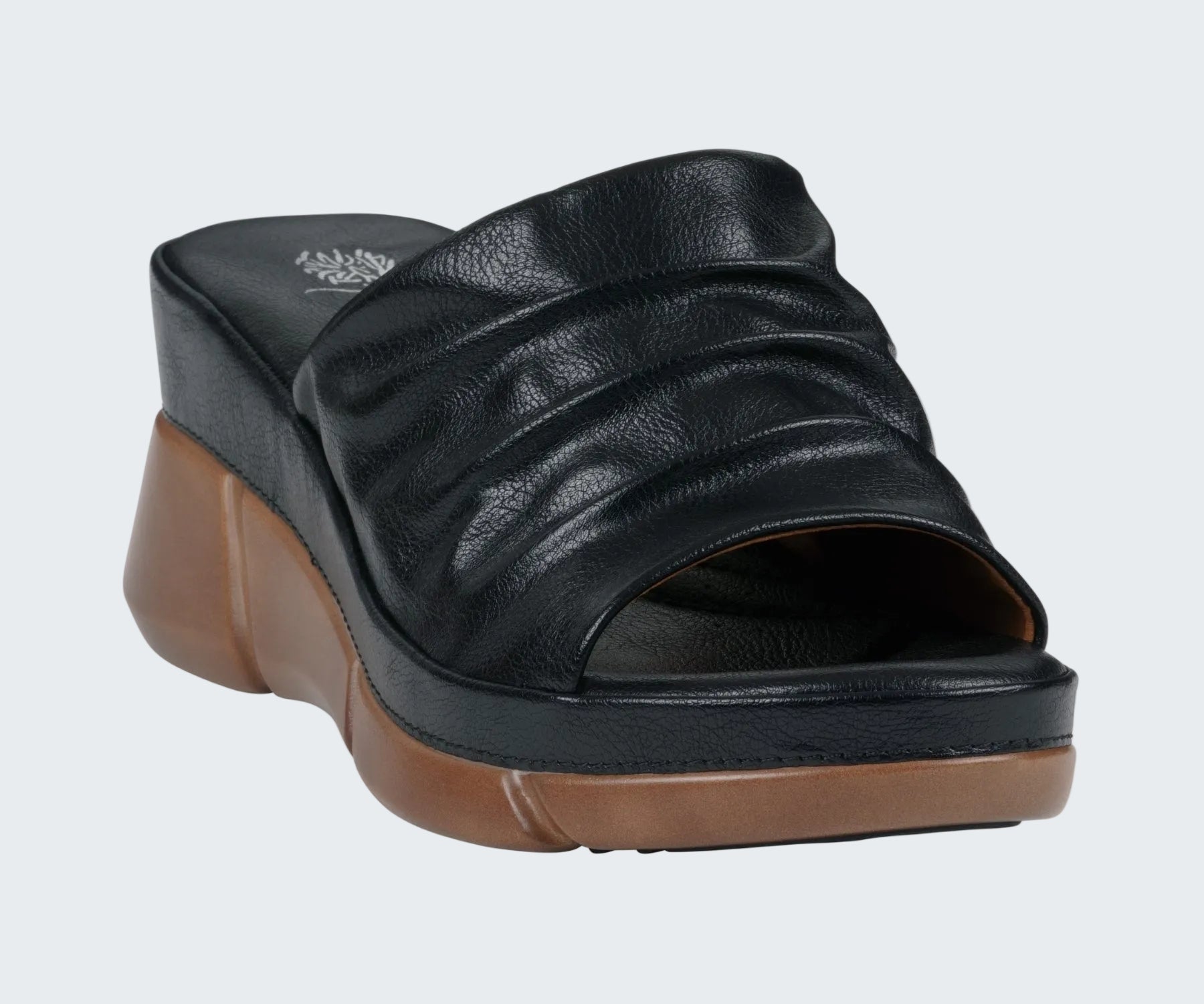 Black wedge sandal with brown sole on a white background