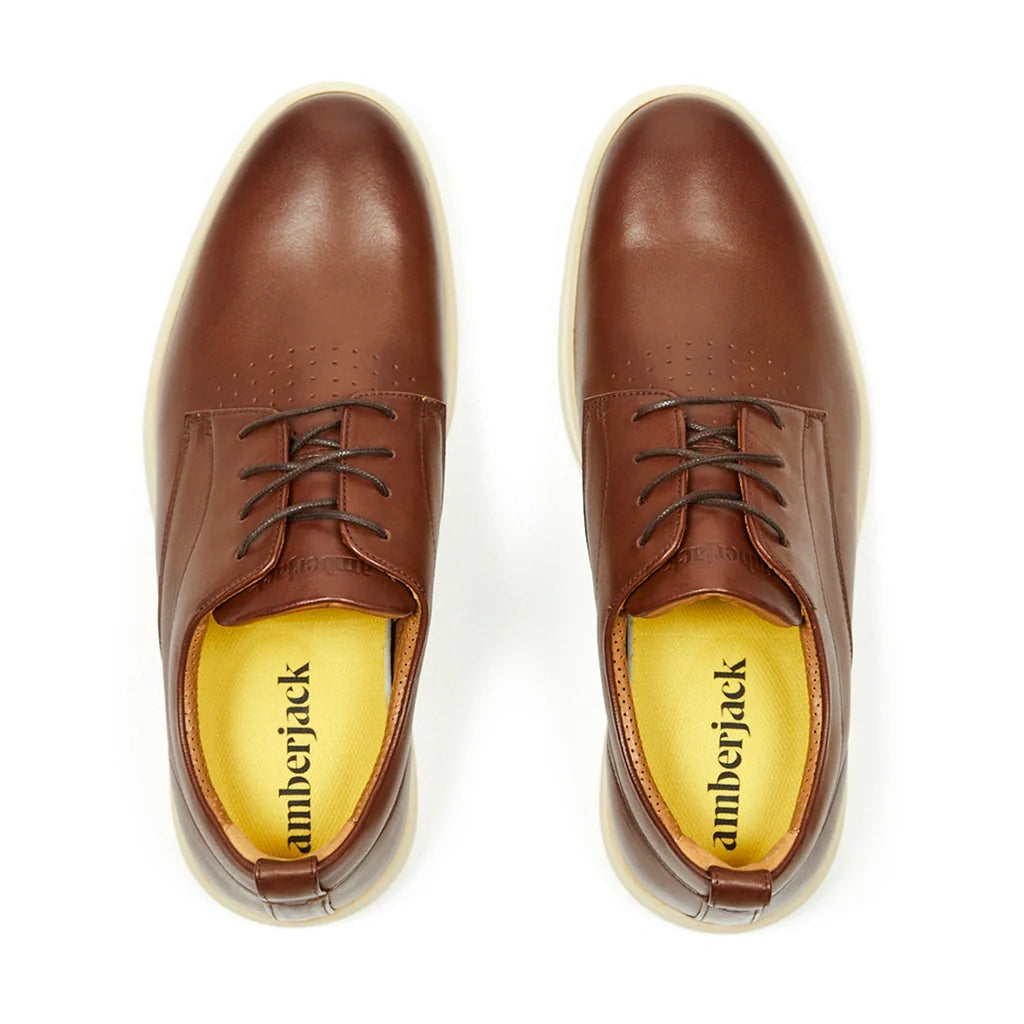Brown leather shoes with 'amberjack' branding on a white background