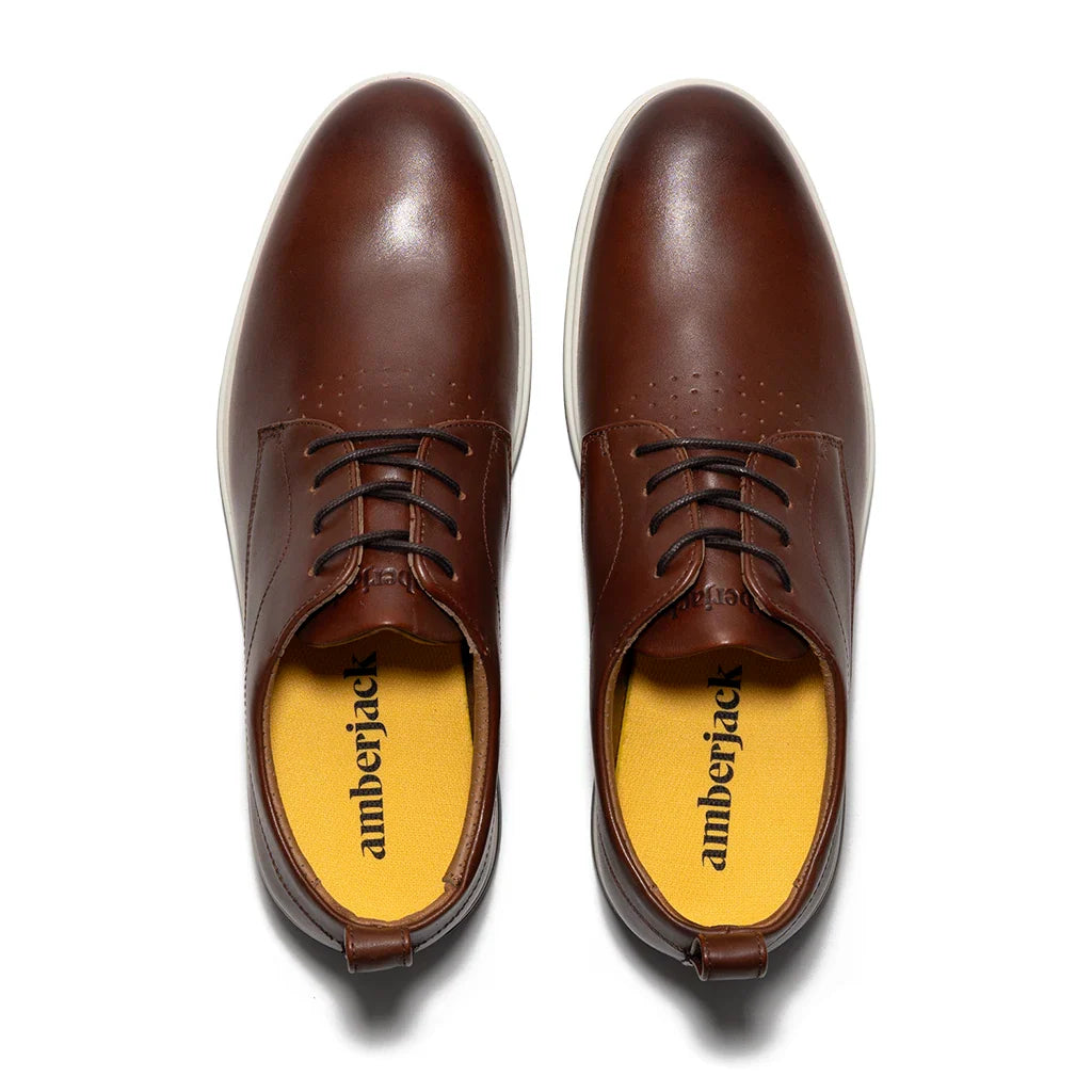 Brown leather shoes with 'amberjack' branding on a white background