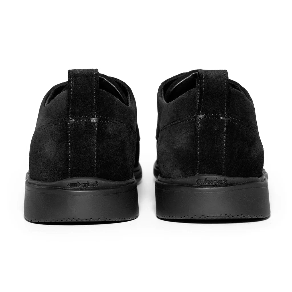 Black suede shoes on a white background