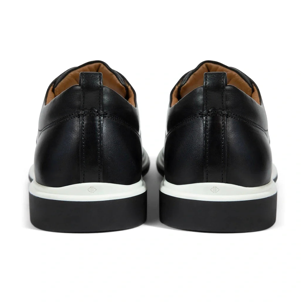 Black leather shoes with white soles on a white background
