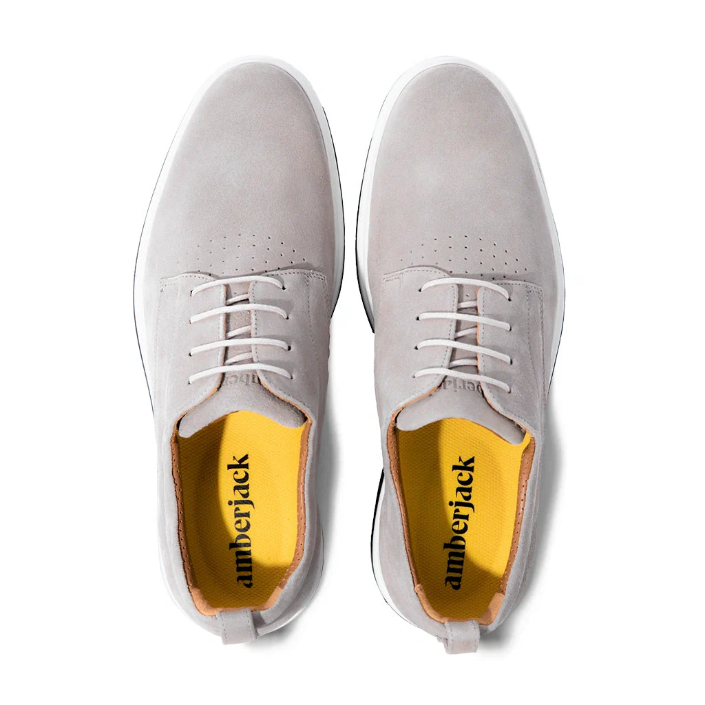 Pair of light gray shoes with 'amberjack' branding on a white background