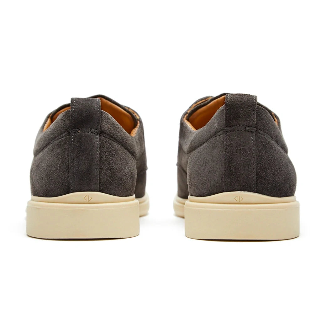 Pair of gray sneakers with beige soles on a white background