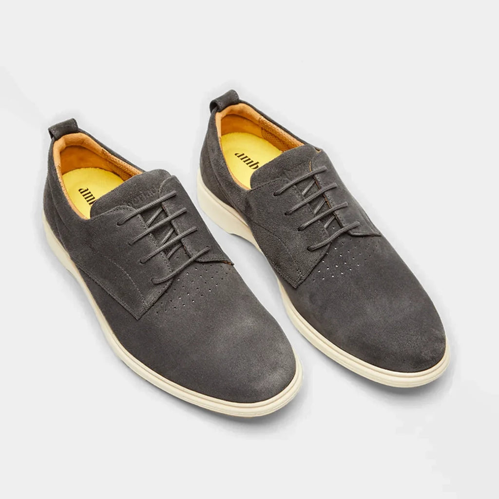 Pair of gray suede shoes on a light gray background