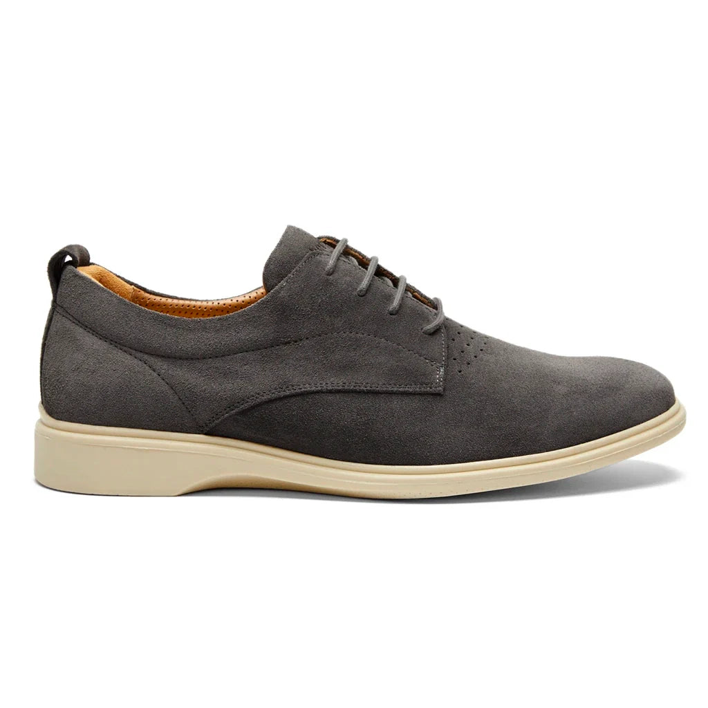 Gray suede shoe with a white sole on a white background