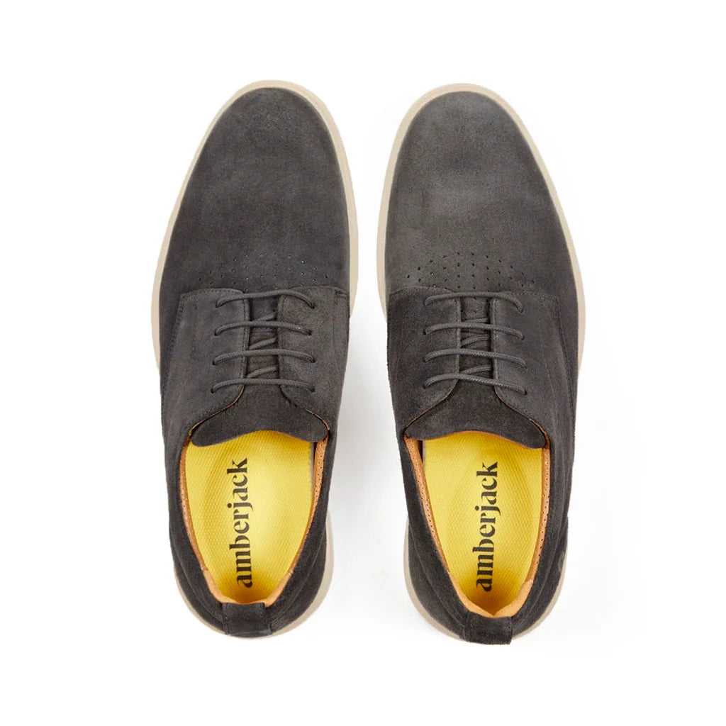 Pair of gray suede shoes with 'amberjack' branding on a white background