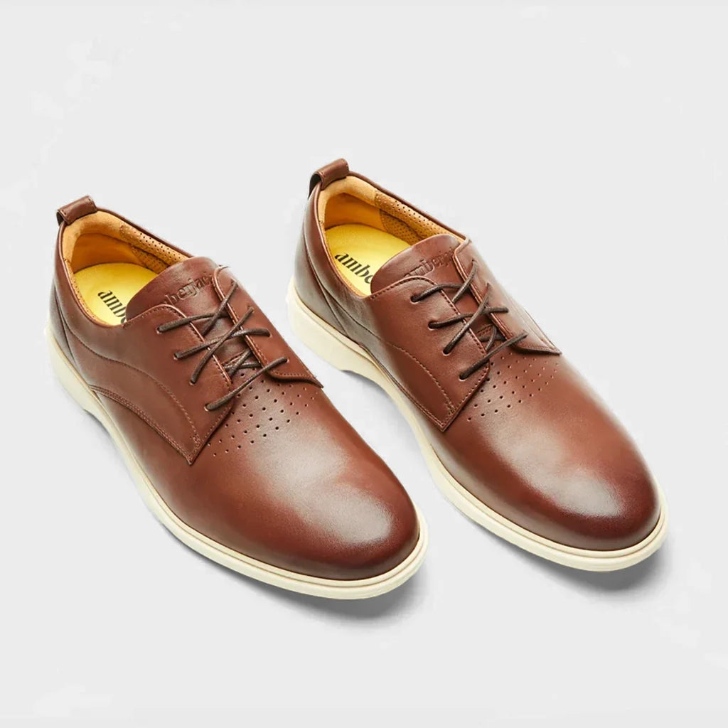 Pair of brown leather shoes on a light gray background