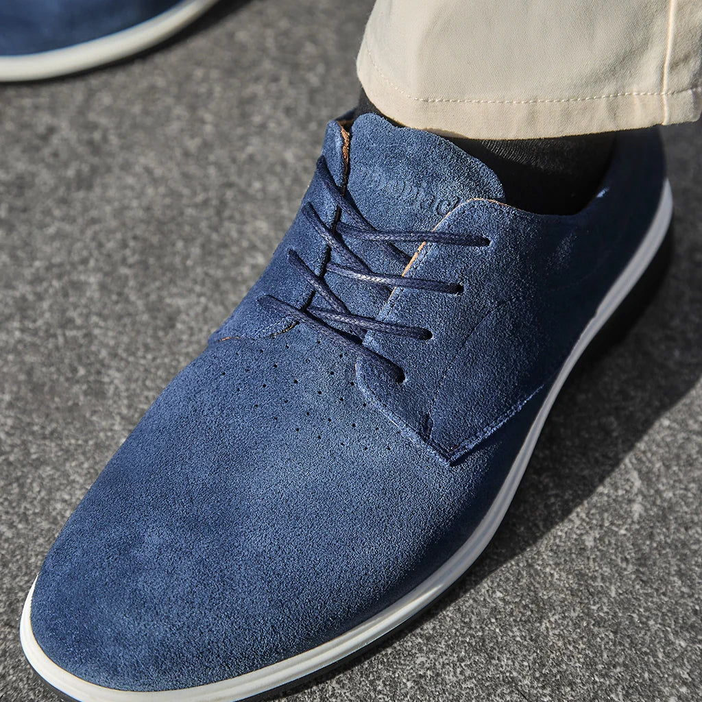 Blue suede shoe on a gray pavement