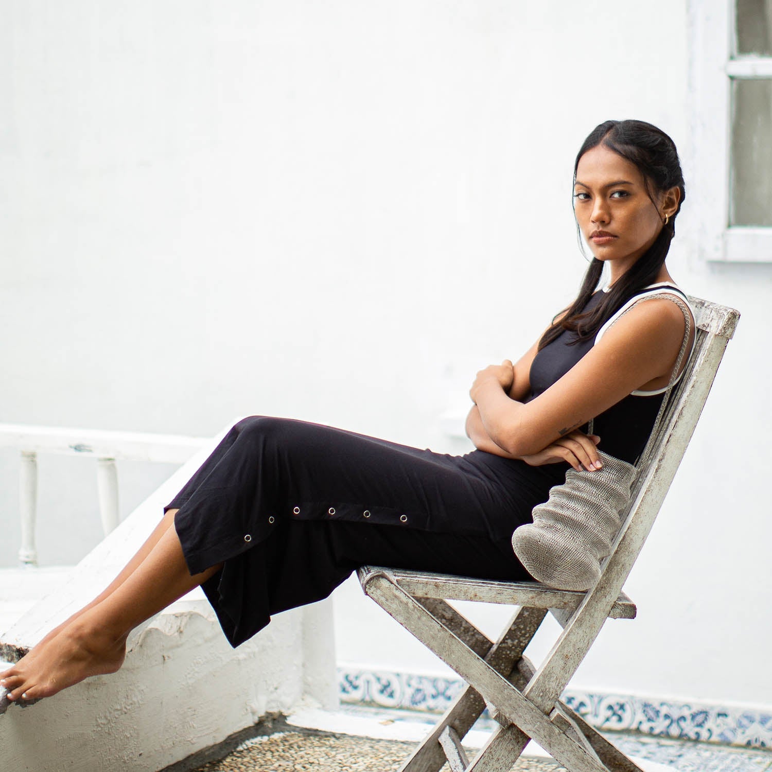 Woman sitting on a chair with a white background