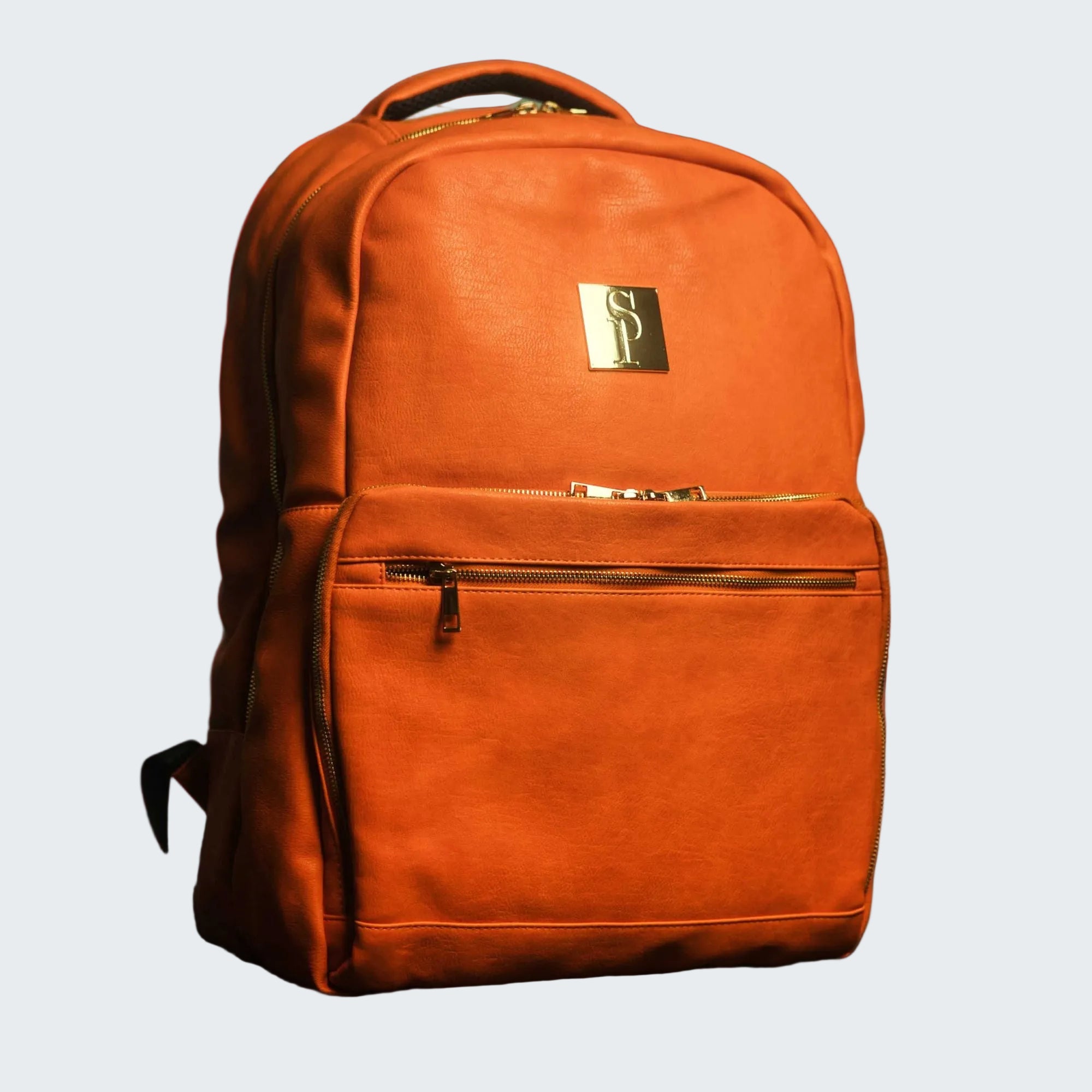 Brown leather backpack with a brand logo on a red background