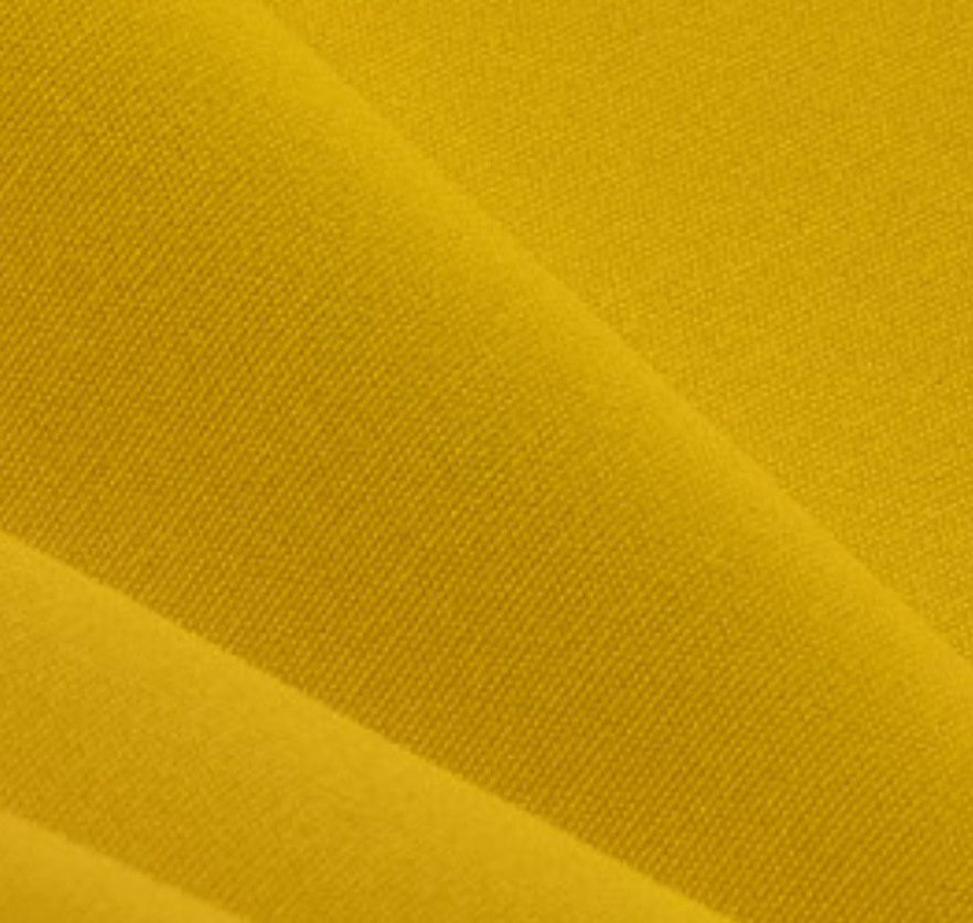 Close-up of yellow fabric with a textured pattern