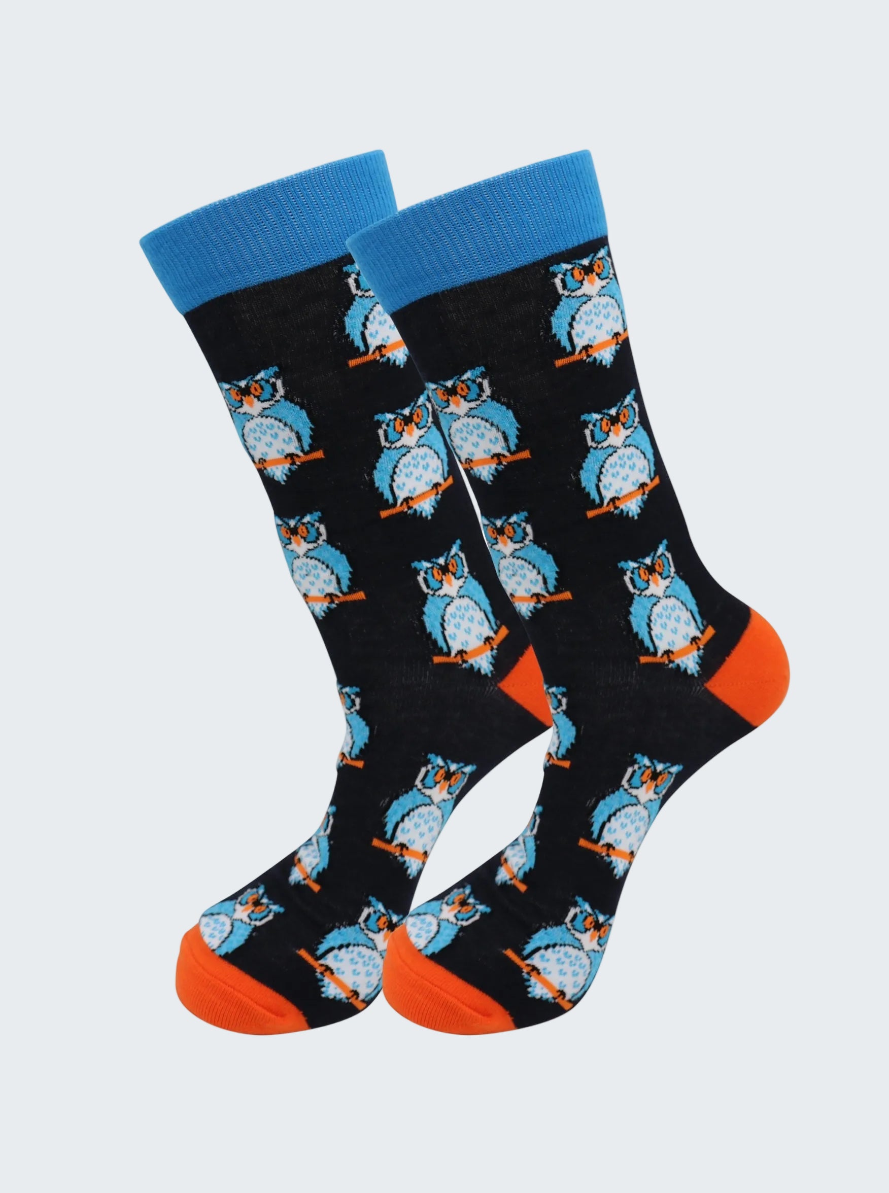 Pair of socks with owl pattern on a black background, blue top, and orange toes.
