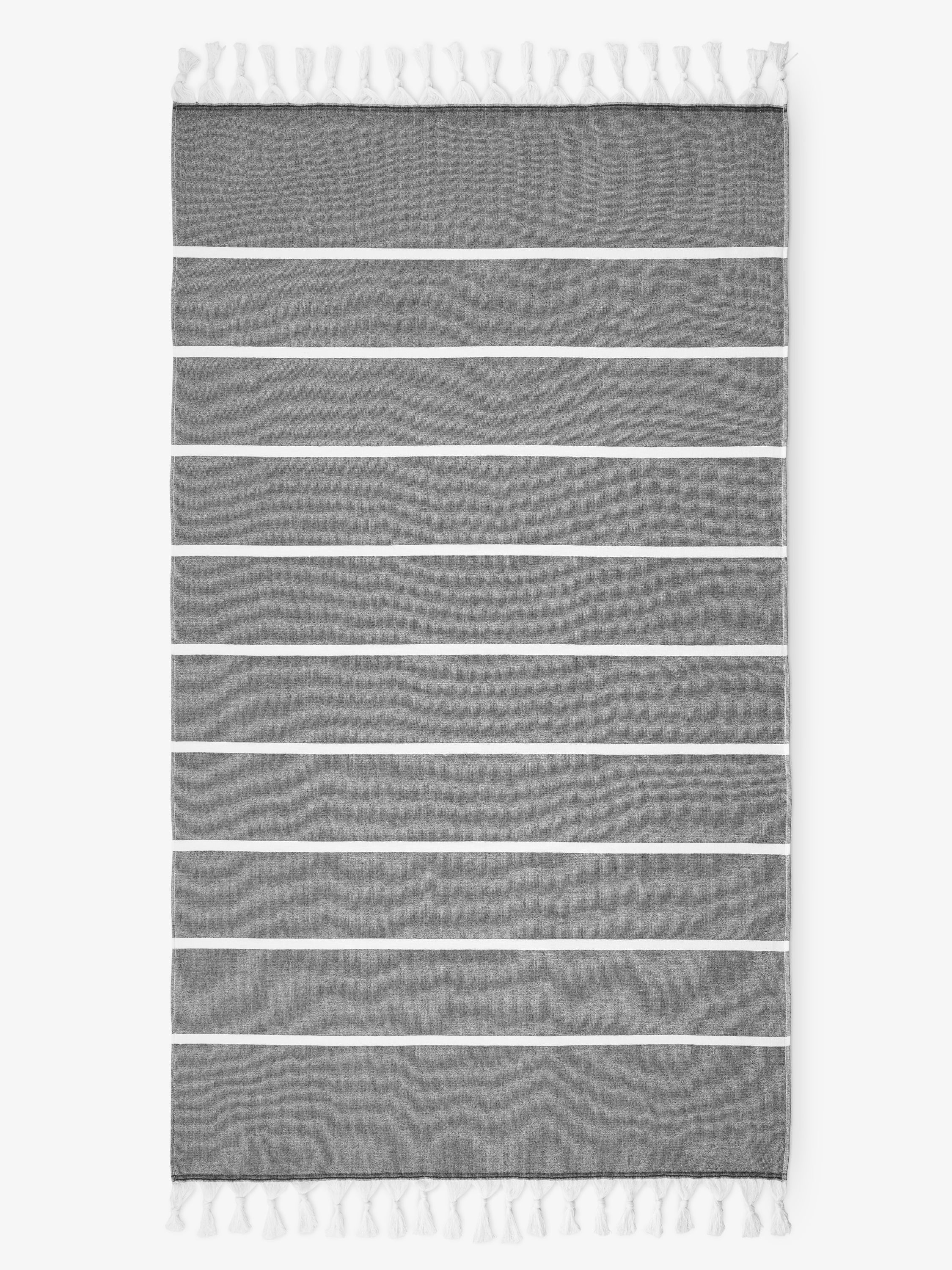 Gray striped rug with white tassels on a white background