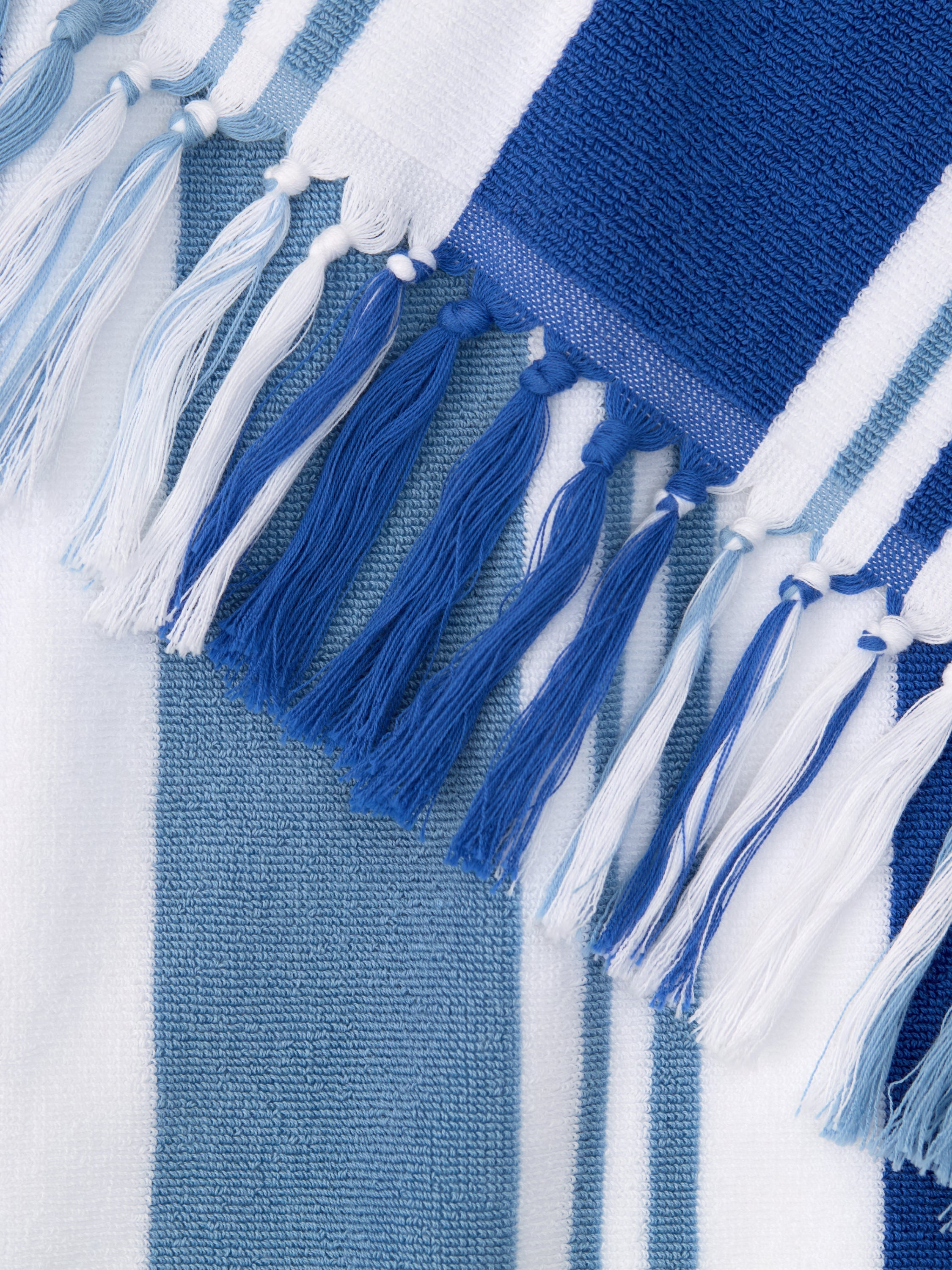 Close-up of a blue and white striped fabric with tassels