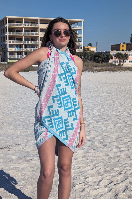Woman on a beach wearing a patterned scarf