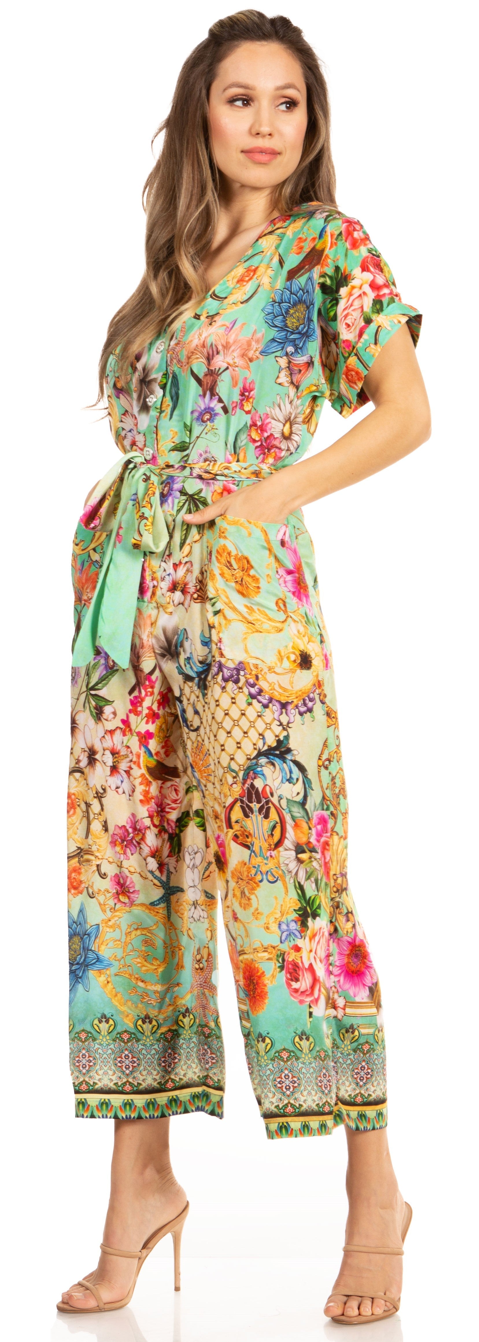 Woman wearing a colorful floral jumpsuit on a white background