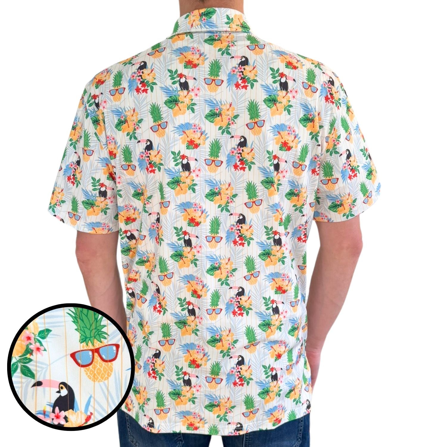 Short-sleeve shirt with tropical pattern featuring toucans, flowers, and sunglasses on a white background.
