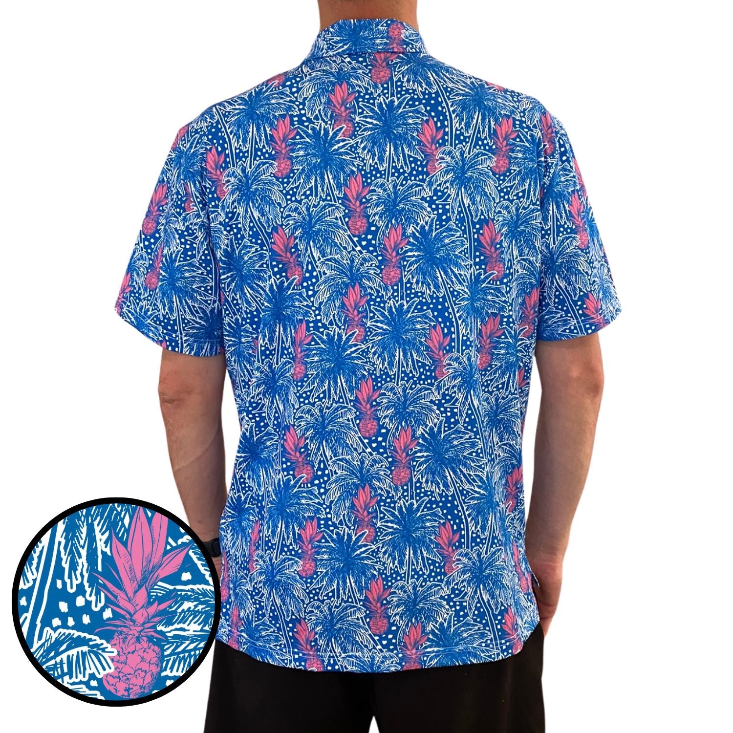 Person wearing a blue and pink floral patterned shirt with a close-up detail on a white background.