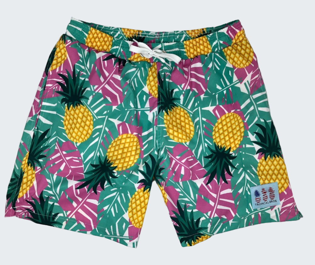 Tropical-themed shorts with pineapple and leaf pattern on a white background