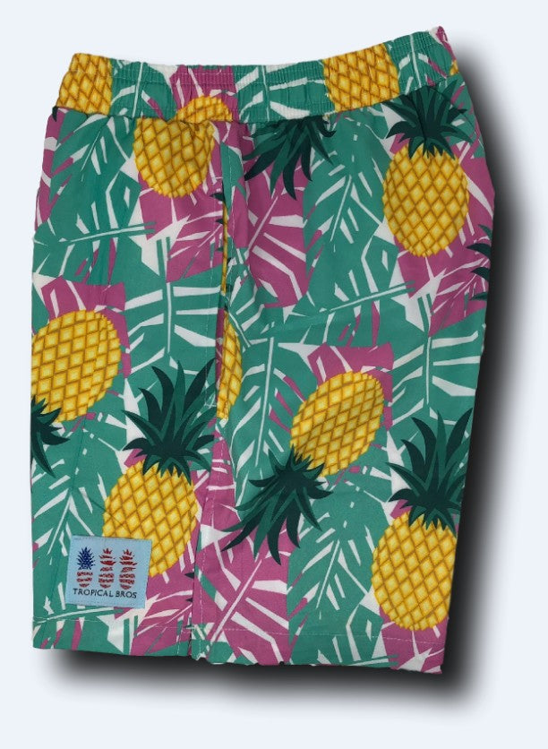 Tropical-themed shorts with pineapple and leaf pattern on a white background