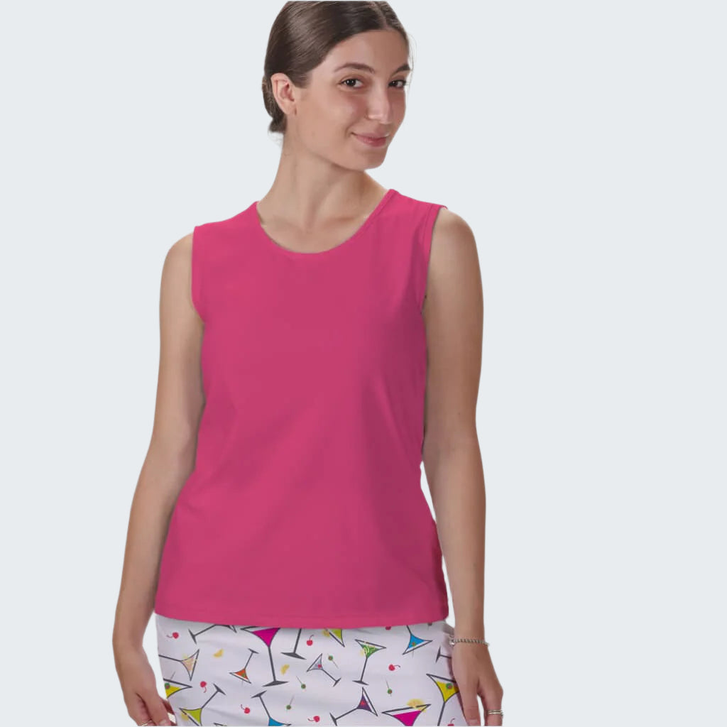 Woman wearing a pink sleeveless top and patterned shorts on a white background
